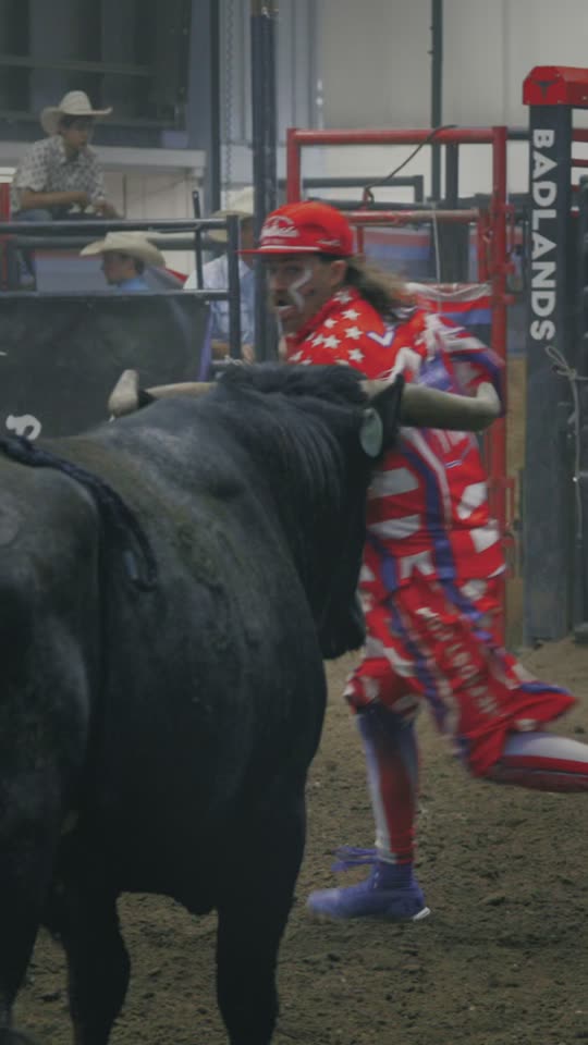 A black bull's horn at the shoulder of a bullfighter in stars and stripes